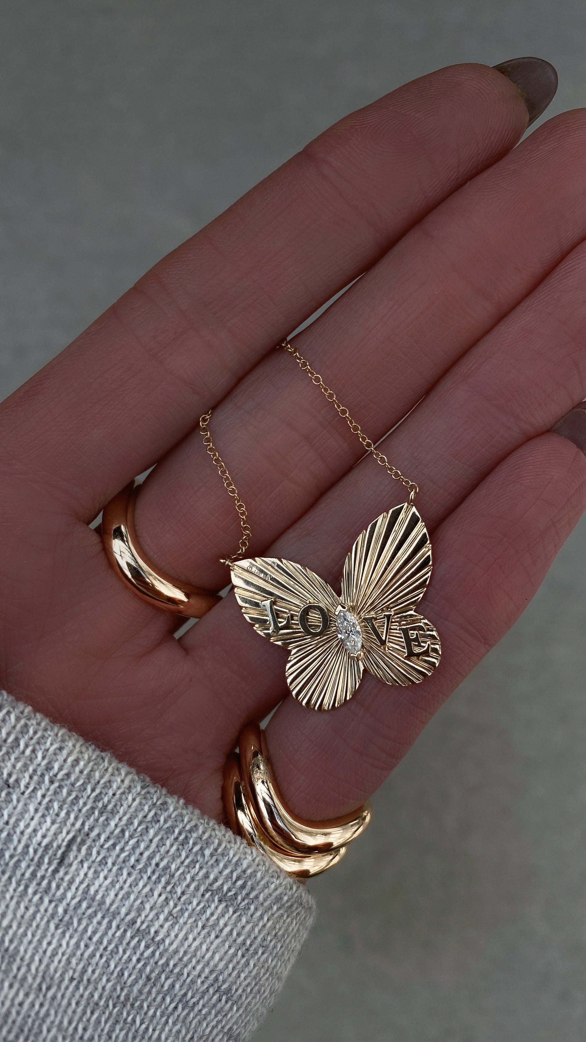 Yellow gold and diamond butterfly burst love necklace